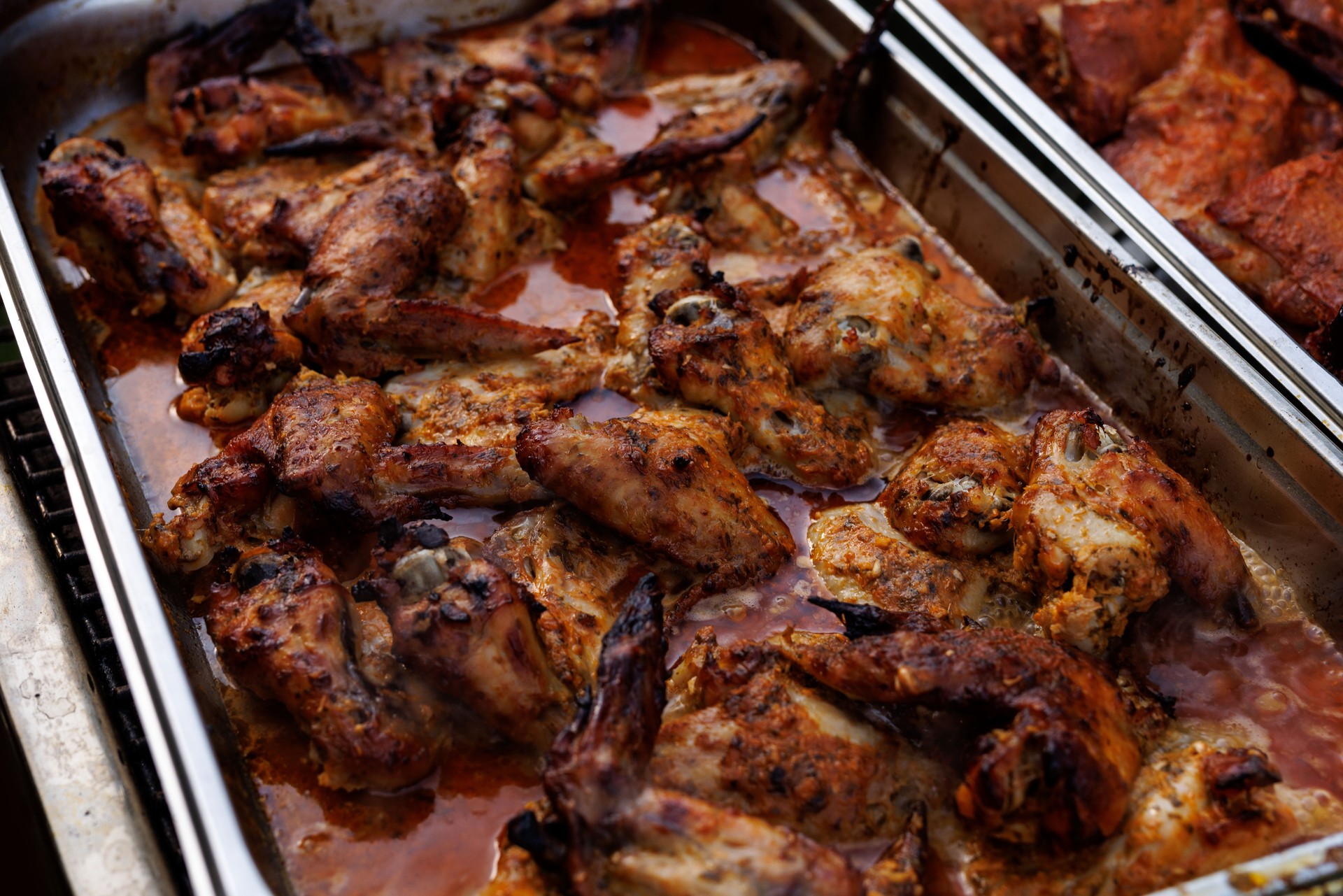 Tray of roasted chicken wings in marinade sauce